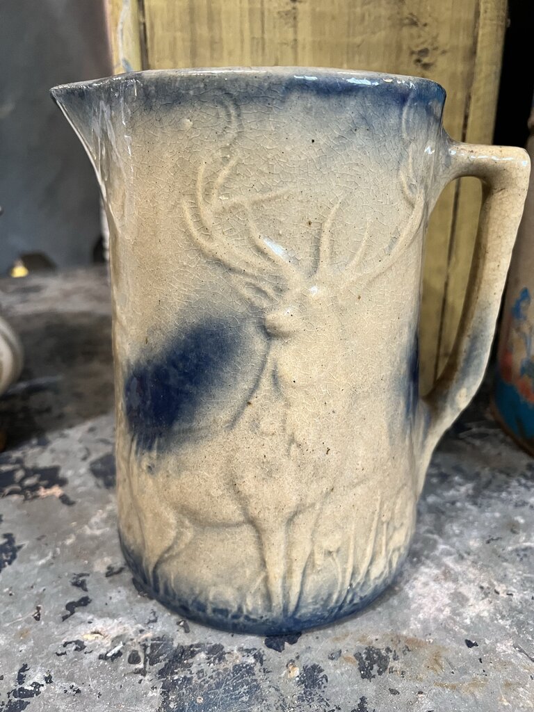 TAN WITH BLUE DEER/FORREST SCENE STONEWARE PITCHER
